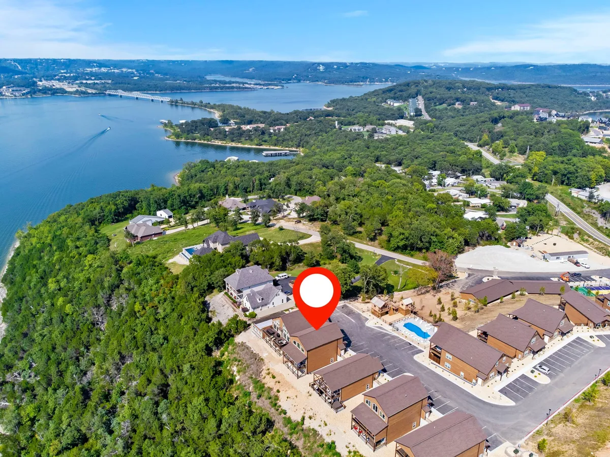 This image captures a tranquil exterior view of Table Rock Lake with the surrounding neighborhood, homes, and lush greenery. The lake itself is prominent and inviting, evoking the spirit of outdoor adventure, while the natural setting emphasizes the proximity to water-based activities like boating, fishing, and wildlife watching.